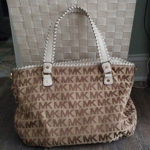White and tan monogram Michael Kors purse.